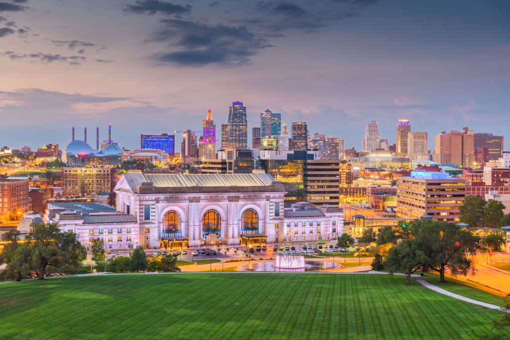 Kansas City, Missouri, USA downtown skyline with Union Station at dusk.